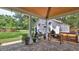 Cozy backyard patio with outdoor seating, barbecue and lush green lawn at 508 Faulkner St, New Smyrna Beach, FL 32168