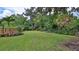 Backyard featuring a well-manicured lawn, mature trees, and a privacy fence enhancing the outdoor space at 508 Faulkner St, New Smyrna Beach, FL 32168