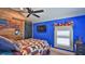 Bedroom featuring ceiling fan, barn door and American flag wall art at 508 Faulkner St, New Smyrna Beach, FL 32168