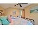 Bedroom featuring ceiling fan, colorful quilt and seahorse decor at 508 Faulkner St, New Smyrna Beach, FL 32168