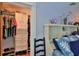 Bedroom with walk-in closet and white shelving and hanging storage at 508 Faulkner St, New Smyrna Beach, FL 32168