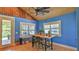 Bright dining area features blue walls, brick floors, and a rustic wood table with seating for four at 508 Faulkner St, New Smyrna Beach, FL 32168