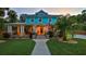 Stunning exterior elevation of a home featuring a wide porch, stone accents, and a well-manicured front yard at 508 Faulkner St, New Smyrna Beach, FL 32168