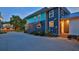 Side view of the charming two-story house with a long driveway and lush landscaping at 508 Faulkner St, New Smyrna Beach, FL 32168
