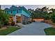 Charming two-story home with a long driveway, detached garage, and lush, green lawn at 508 Faulkner St, New Smyrna Beach, FL 32168