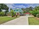 Exterior view showing the well-manicured lawn, driveway, garage, and landscaping around the house at 508 Faulkner St, New Smyrna Beach, FL 32168