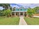 Charming two-story home with well-manicured lawn and inviting front porch with traditional landscaping at 508 Faulkner St, New Smyrna Beach, FL 32168