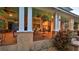 Inviting front porch with stone accents, rocking chairs, ceiling fans, and warm, ambient lighting at 508 Faulkner St, New Smyrna Beach, FL 32168
