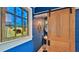 Unique half bath with blue plank walls, sliding barn door, and decorative window at 508 Faulkner St, New Smyrna Beach, FL 32168