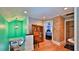 Hallway with view into blue themed bedroom, wooden floors, and brick wall at 508 Faulkner St, New Smyrna Beach, FL 32168
