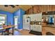 Charming kitchen with blue walls, brick floors, and classic white cabinetry at 508 Faulkner St, New Smyrna Beach, FL 32168