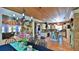 Open-concept kitchen view featuring a dining room, kitchen island, modern appliances, and rustic brick accents at 508 Faulkner St, New Smyrna Beach, FL 32168