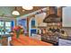Farmhouse-style kitchen featuring brick accents, stainless steel appliances, and custom cabinetry at 508 Faulkner St, New Smyrna Beach, FL 32168