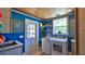 Bright laundry room with blue walls, wood ceiling, utility sink, and washer/dryer at 508 Faulkner St, New Smyrna Beach, FL 32168