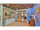 Open concept living area featuring brick walls, hardwood floors, and coffered ceilings at 508 Faulkner St, New Smyrna Beach, FL 32168