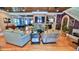 Spacious living room with hardwood floors, brick fireplace, and open layout with dining area at 508 Faulkner St, New Smyrna Beach, FL 32168
