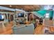 Cozy living room with hardwood floors, brick fireplace, access to stairs, and ample natural light at 508 Faulkner St, New Smyrna Beach, FL 32168