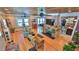 Bright living room with hardwood floors, brick fireplace, and ceiling fan with access to kitchen at 508 Faulkner St, New Smyrna Beach, FL 32168