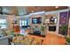 Inviting living room with brick fireplace, hardwood floors, and open access to the dining room and kitchen at 508 Faulkner St, New Smyrna Beach, FL 32168