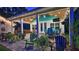 Outdoor patio with a covered area, ceiling fans, dining area, and multiple seating options at 508 Faulkner St, New Smyrna Beach, FL 32168