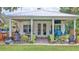 Outdoor patio seating area with green chairs, grilling area, and a view of the spacious backyard at 508 Faulkner St, New Smyrna Beach, FL 32168