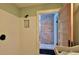 White tiled shower with shower niche, with a view into brick wall room at 508 Faulkner St, New Smyrna Beach, FL 32168