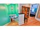 Stairway with turquoise walls leads to the lower level, showcasing a decorative wooden cabinet at 508 Faulkner St, New Smyrna Beach, FL 32168