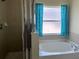 Bathroom featuring a bathtub, a shower, and a window with curtains at 519 Aeolian Dr, New Smyrna Beach, FL 32168