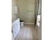 Bright bathroom with marble countertop vanity, walk-in shower, and new flooring at 519 Aeolian Dr, New Smyrna Beach, FL 32168