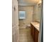 Bright bathroom featuring a wooden vanity, framed mirror and light hardwood flooring at 519 Aeolian Dr, New Smyrna Beach, FL 32168