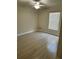Cozy bedroom featuring neutral colored walls, light hardwood flooring and a ceiling fan at 519 Aeolian Dr, New Smyrna Beach, FL 32168
