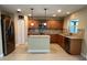 Modern kitchen with stainless steel appliances, wooden cabinets, and a central island at 519 Aeolian Dr, New Smyrna Beach, FL 32168