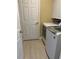 Convenient laundry room with modern appliances and neutral colored tile flooring at 519 Aeolian Dr, New Smyrna Beach, FL 32168