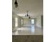 Spacious living room with tile flooring, ceiling fan, and natural light from large windows at 519 Aeolian Dr, New Smyrna Beach, FL 32168