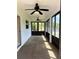Enclosed porch with glass windows, a ceiling fan and lots of natural light at 519 Aeolian Dr, New Smyrna Beach, FL 32168