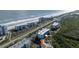 Aerial view showcasing condo near beach, parking, and tennis courts at 5300 S Atlantic Ave # 17-207, New Smyrna Beach, FL 32169