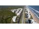Expansive aerial shot of beachside condo community surrounded by ocean and marshes at 5300 S Atlantic Ave # 17-207, New Smyrna Beach, FL 32169