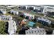 Aerial shot showcasing the community pool, tennis courts, greenary, and condo buildings at 5300 S Atlantic Ave # 17-207, New Smyrna Beach, FL 32169
