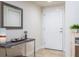 Neutral entryway featuring tile floors, a console table with decor, and a decorative framed mirror above at 5300 S Atlantic Ave # 17-207, New Smyrna Beach, FL 32169