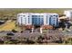 Exterior of condo building with tropical landscaping, parking and secure entry at 5300 S Atlantic Ave # 17-207, New Smyrna Beach, FL 32169