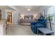Comfortable bedroom with a view to the en suite bathroom and an inviting blue recliner at 5300 S Atlantic Ave # 17-207, New Smyrna Beach, FL 32169