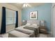 Comfortable bedroom with a window, featuring simple yet elegant furniture and a calming color palette at 5300 S Atlantic Ave # 19-403, New Smyrna Beach, FL 32169