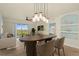 Open-concept dining area with modern lighting, seamlessly connecting to the living room and kitchen at 5300 S Atlantic Ave # 19-403, New Smyrna Beach, FL 32169