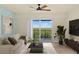 Bright living room with a sliding glass door, offering scenic views and plenty of natural light at 5300 S Atlantic Ave # 19-403, New Smyrna Beach, FL 32169