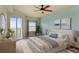 Inviting main bedroom with a balcony, featuring soft colors, comfortable bedding, and ample natural light at 5300 S Atlantic Ave # 19-403, New Smyrna Beach, FL 32169