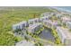 Gorgeous aerial view of a condo community with a pond and fountain in the center at 5300 S Atlantic Ave # 9-206, New Smyrna Beach, FL 32169