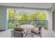Cozy balcony with seating area and lovely views of surrounding trees and clear skies at 5300 S Atlantic Ave # 9-206, New Smyrna Beach, FL 32169