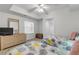 Bright bedroom featuring two beds, a dresser with a mirror, and a ceiling fan for added comfort at 5300 S Atlantic Ave # 9-206, New Smyrna Beach, FL 32169
