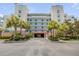 Inviting condo building features a covered drive, lush tropical landscaping and well-maintained facade at 5300 S Atlantic Ave # 9-206, New Smyrna Beach, FL 32169