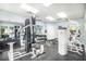 Community gym featuring modern weight machines, exercise equipment, mirrored wall, and rubberized flooring at 5300 S Atlantic Ave # 9-206, New Smyrna Beach, FL 32169
